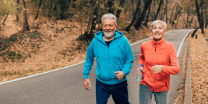 Older couple on walk or jog in fall.